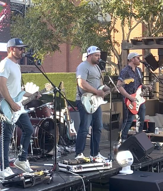 The band playing an outdoor show